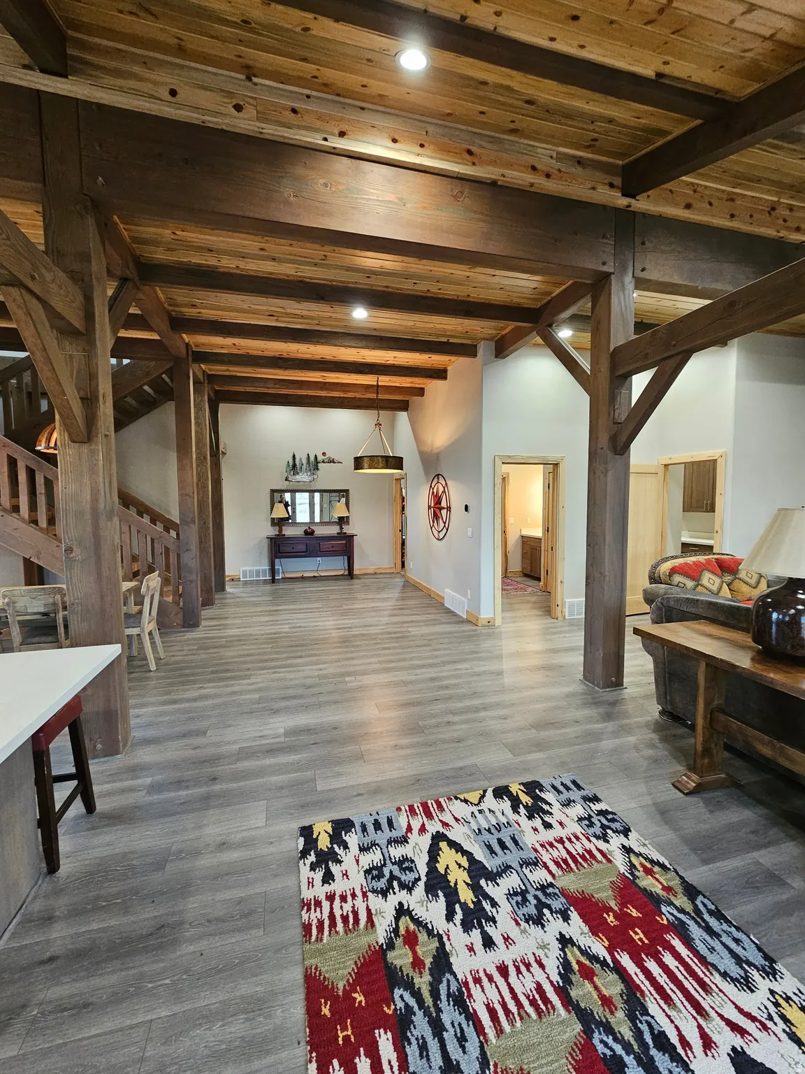 Spacious interior featuring exposed wood beams and wood-finish ceiling