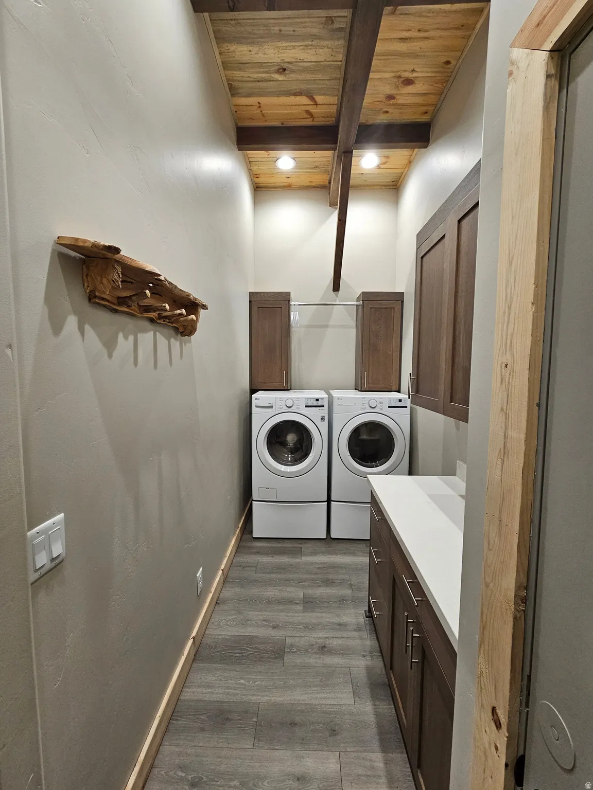Laundry area featuring a wood-finish plank ceiling with exposed beams, recessed lighting, and wood-finish flooring