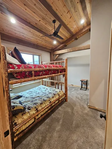 Bedroom with vaulted wood ceiling with exposed beams, recessed lighting, and a ceiling fan
