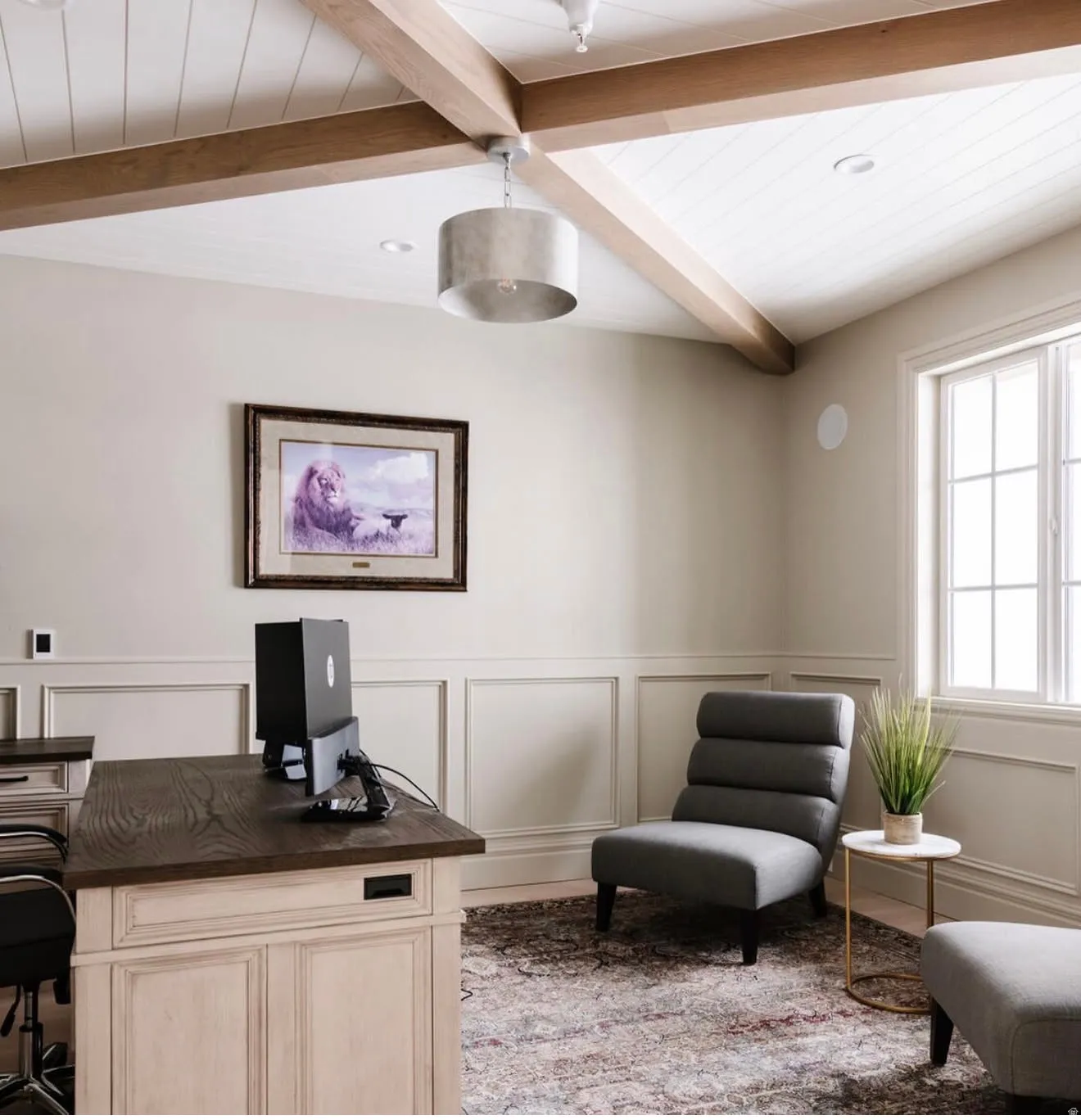 Vaulted ceiling with exposed wood beams and white plank detailing, complemented by a drum pendant light fixture