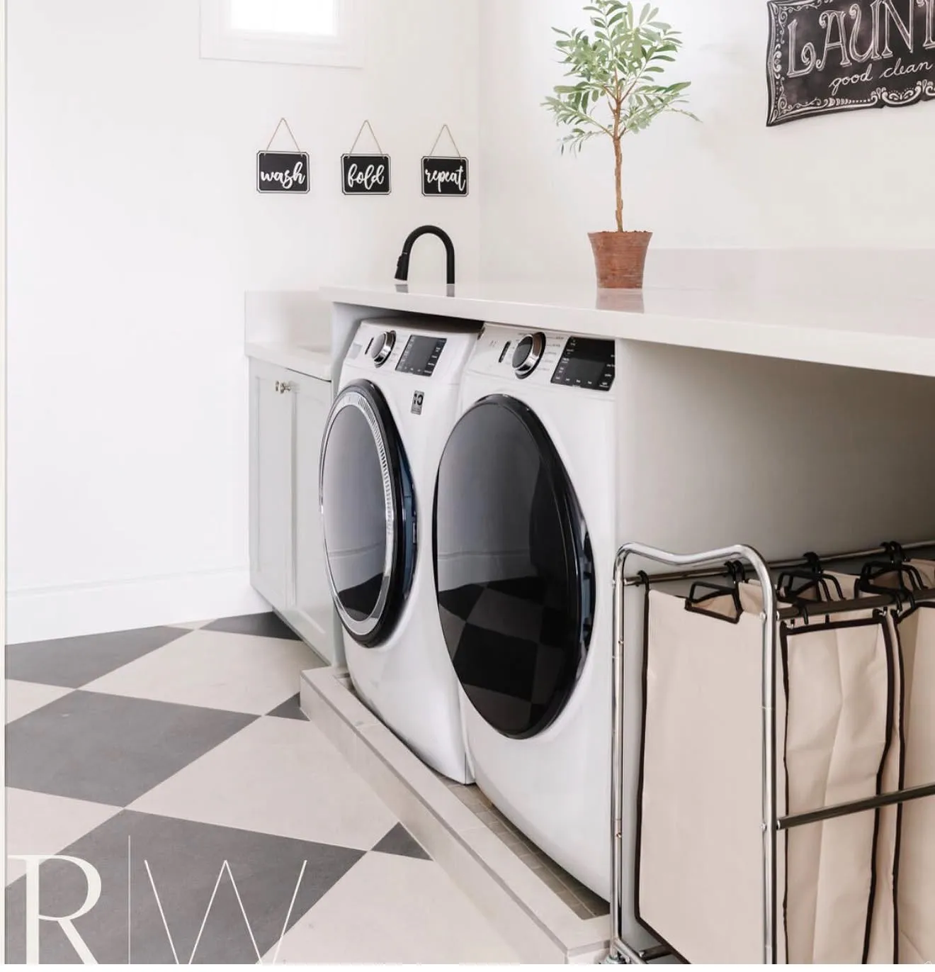 Dedicated laundry area featuring a checkerboard floor, built-in cabinetry, a countertop with an integrated sink, and a high-arc faucet