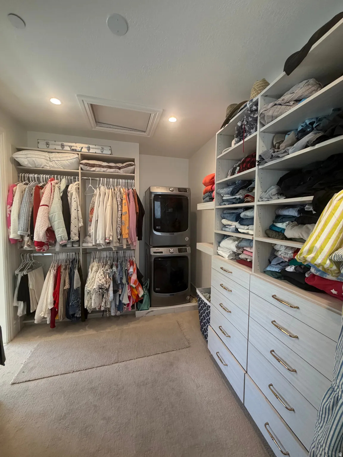 Custom closet system featuring extensive shelving and drawer storage