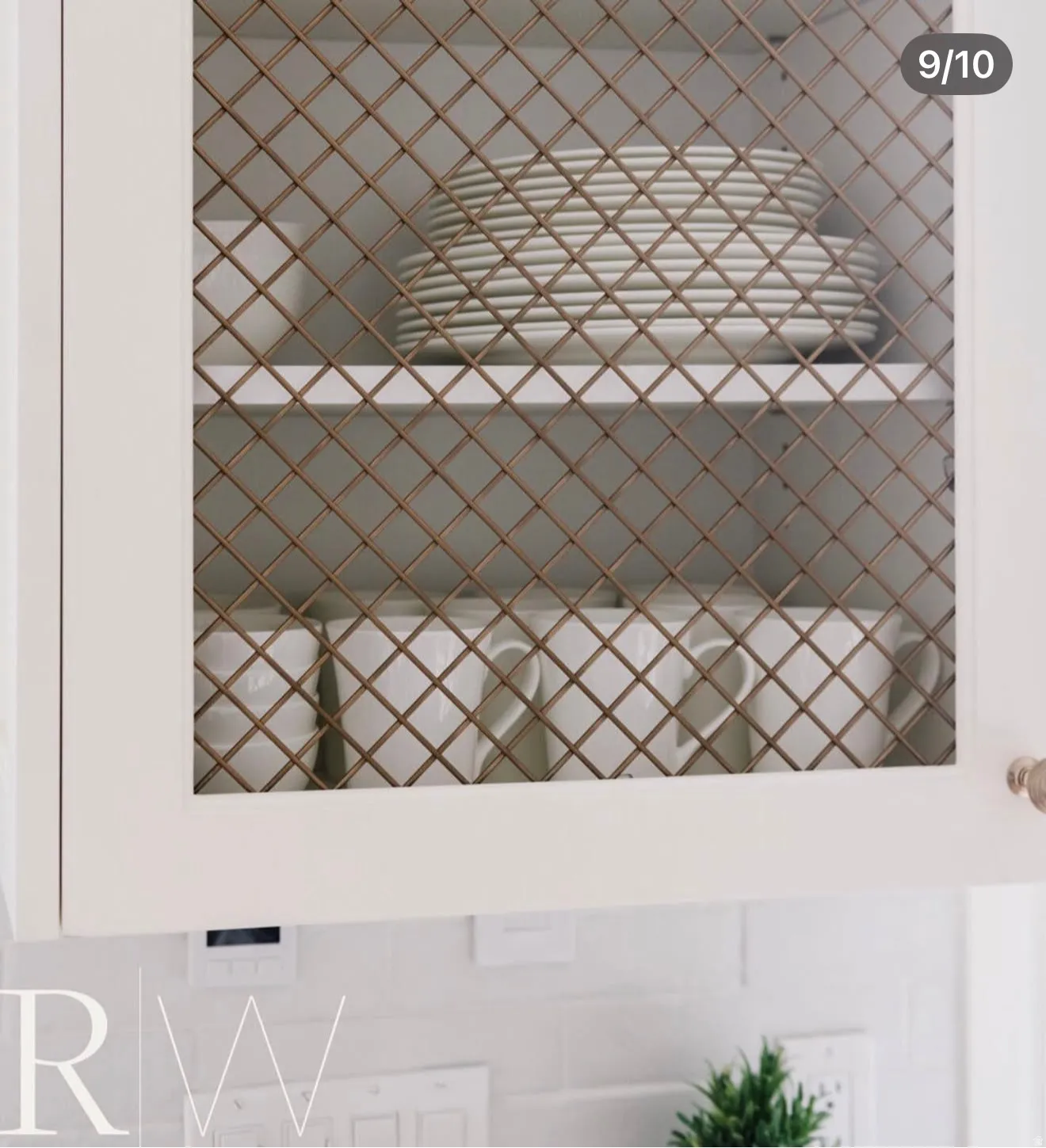 White cabinetry featuring decorative wire mesh inserts, brushed nickel hardware, and a white subway tile backsplash