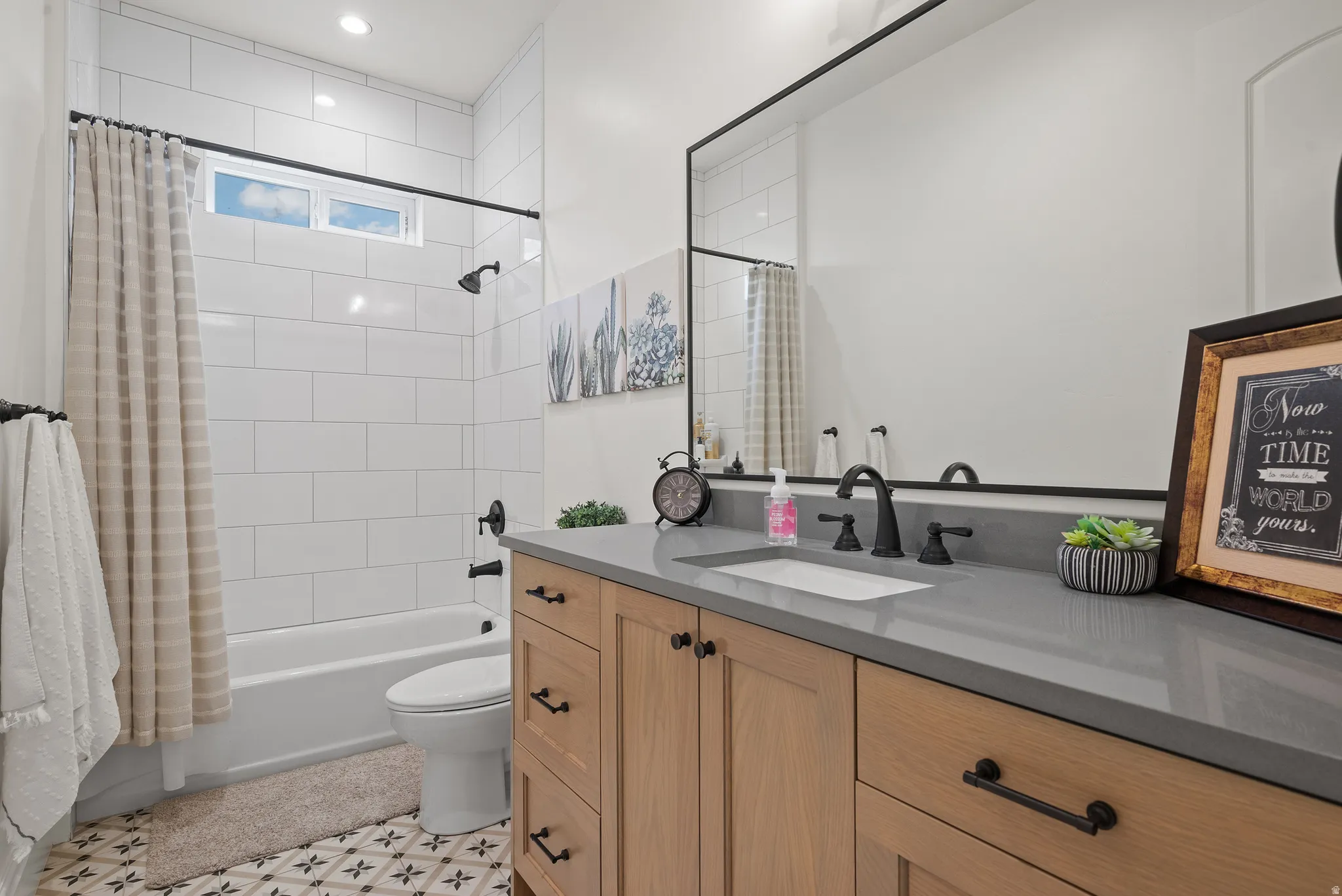 Modern bathroom featuring a single vanity with wood-finish cabinetry and a gray countertop