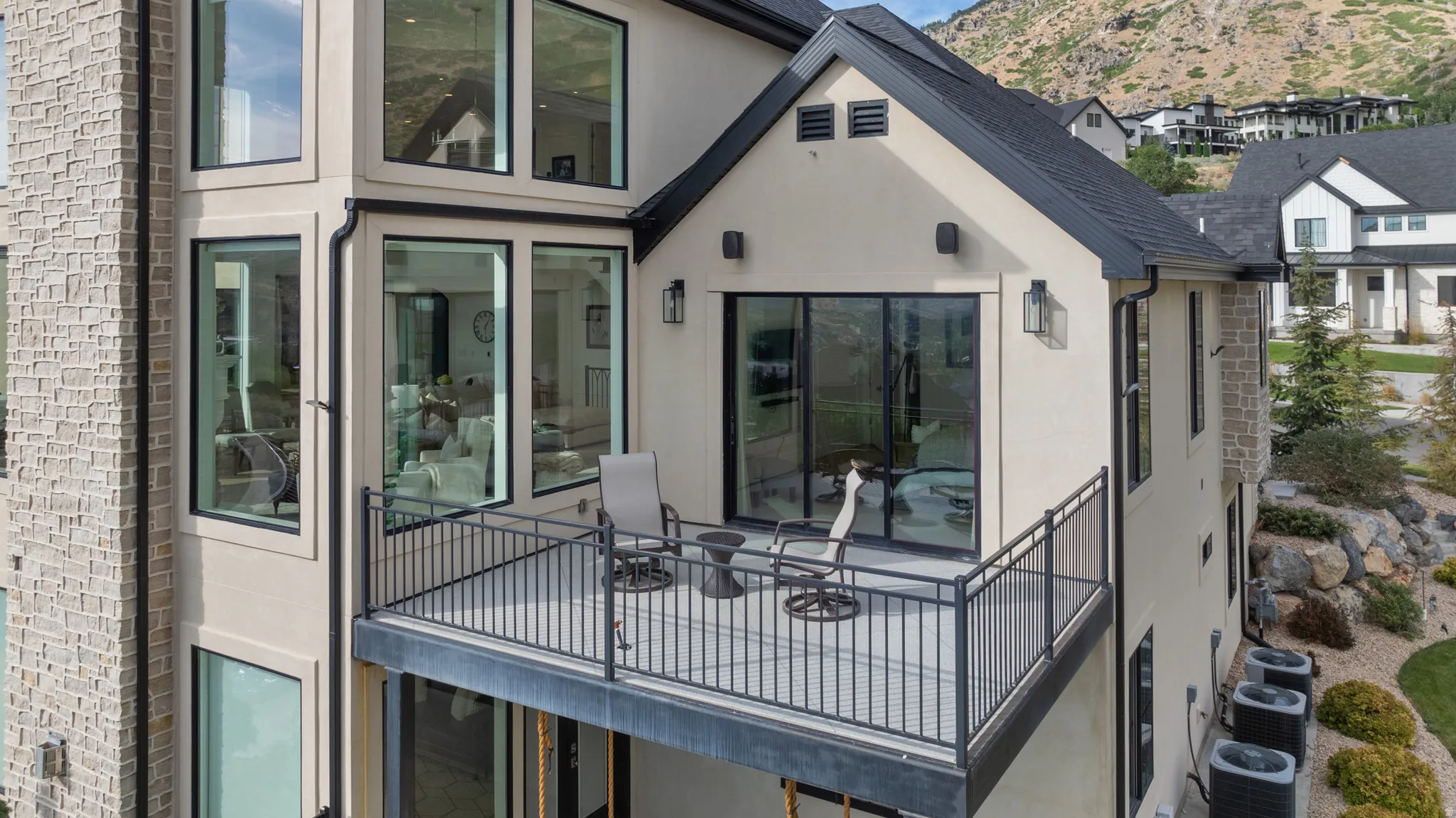 Exterior balcony featuring dark metal railings and a glass sliding door