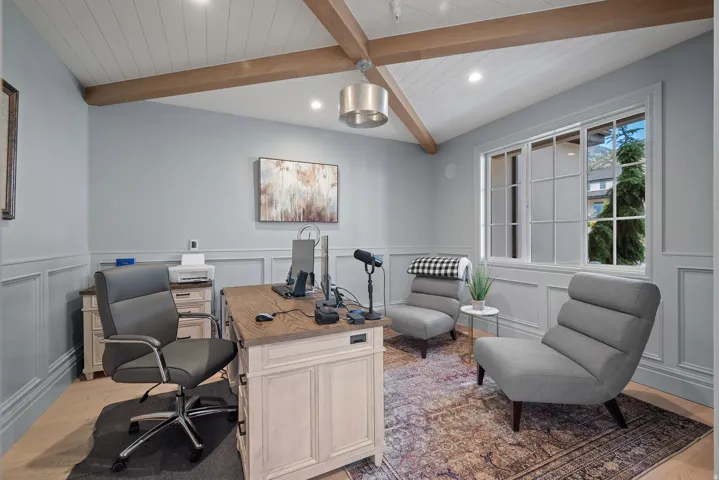 Vaulted ceiling with exposed wood beams and beadboard finish