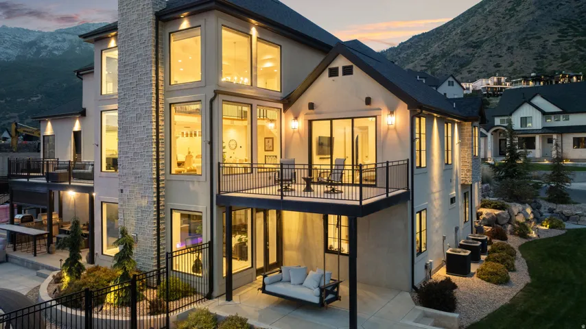 Contemporary residence featuring a multi-story exterior with stucco and stone accents