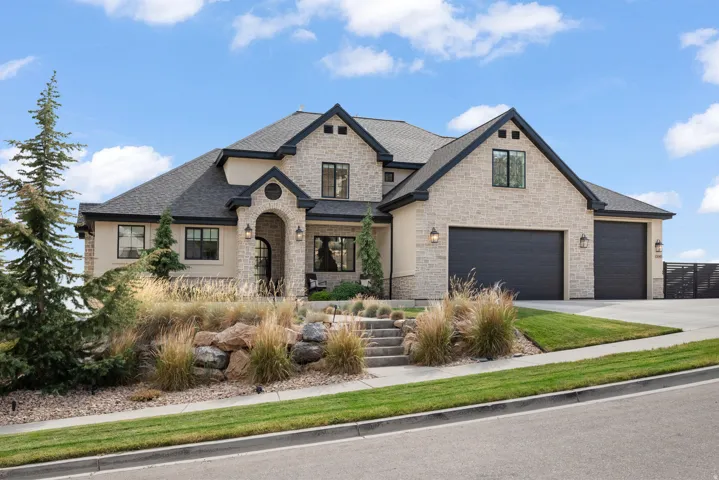 Stucco and stone facade with dark trim accents