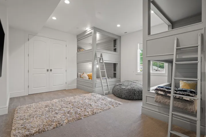 Built-in bunk beds with integrated lighting and shiplap accents