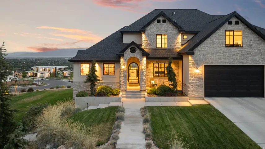 Stone veneer and stucco exterior with dark trim accents