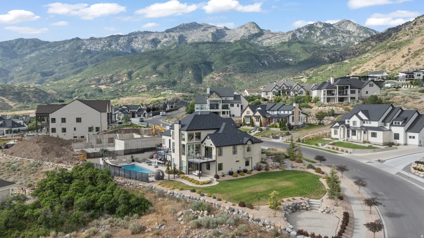 Hillside property with a private pool, an expansive lawn, and balconies offering mountain scenery