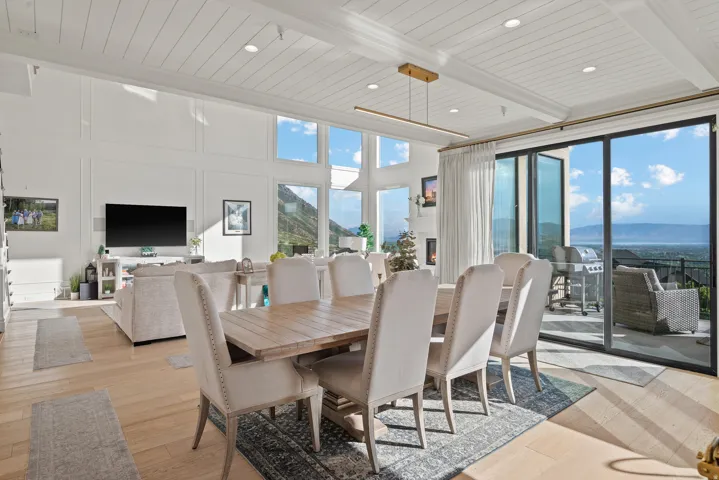 Expansive open-concept living space with high ceilings and wood-finish flooring