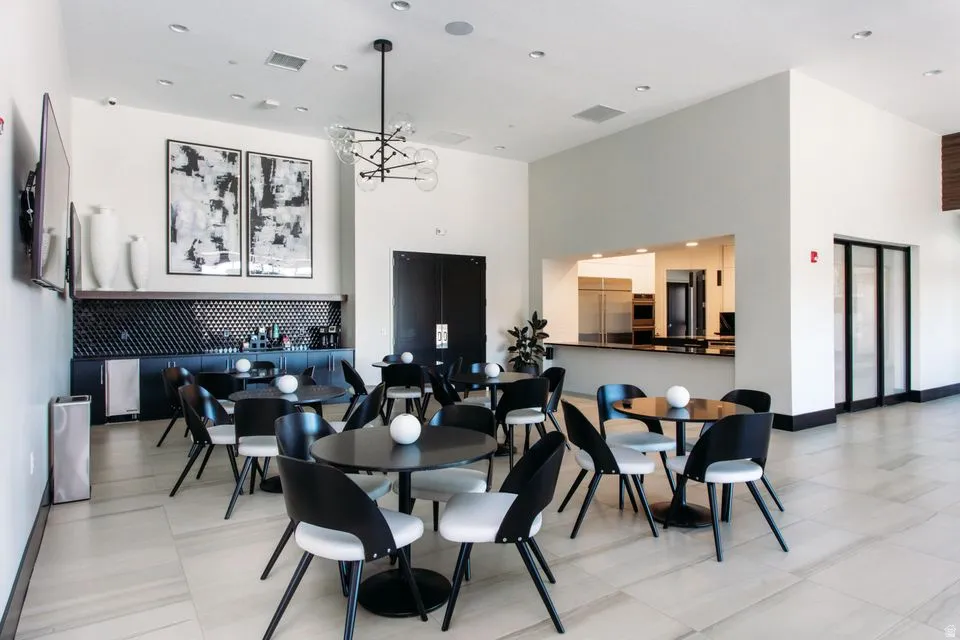 Spacious common area featuring high ceilings, recessed lighting, and large format tile flooring