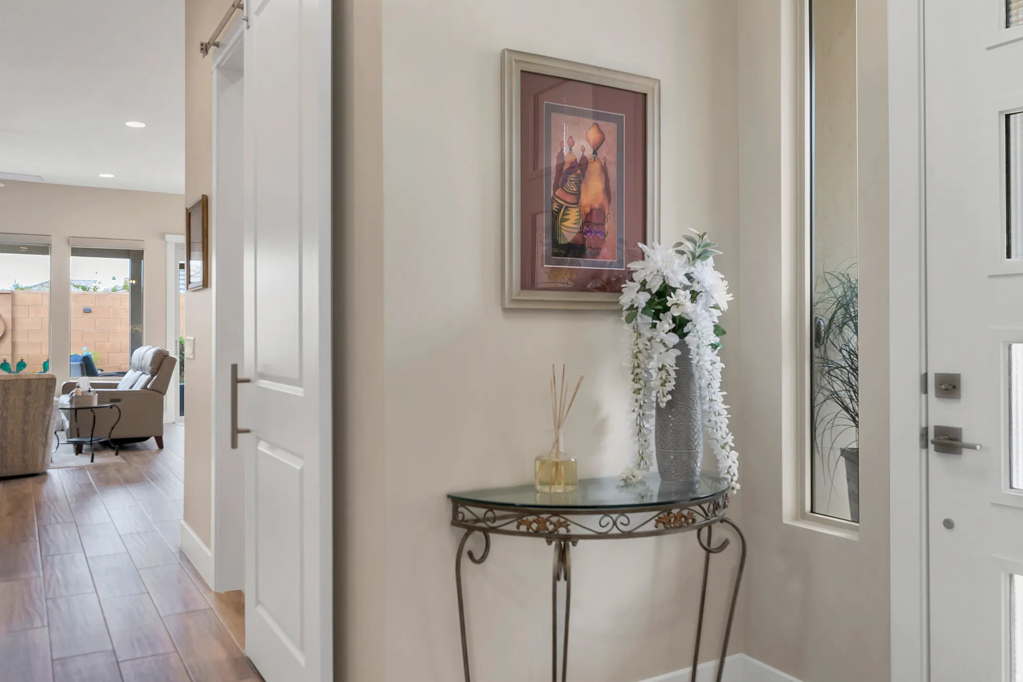 Entryway featuring a white paneled door with frosted glass inserts, sidelight, and wood-finish flooring