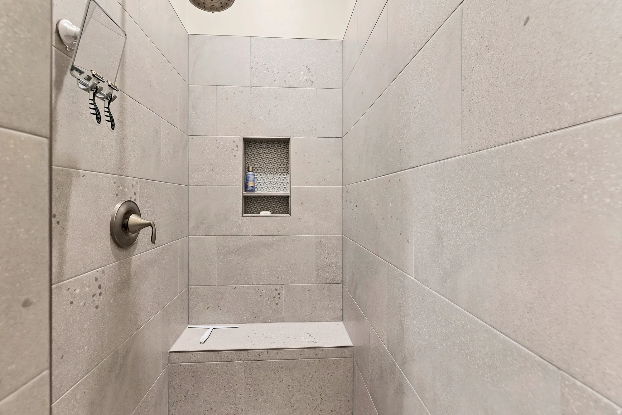 Walk-in shower with large-format light grey wall tiling