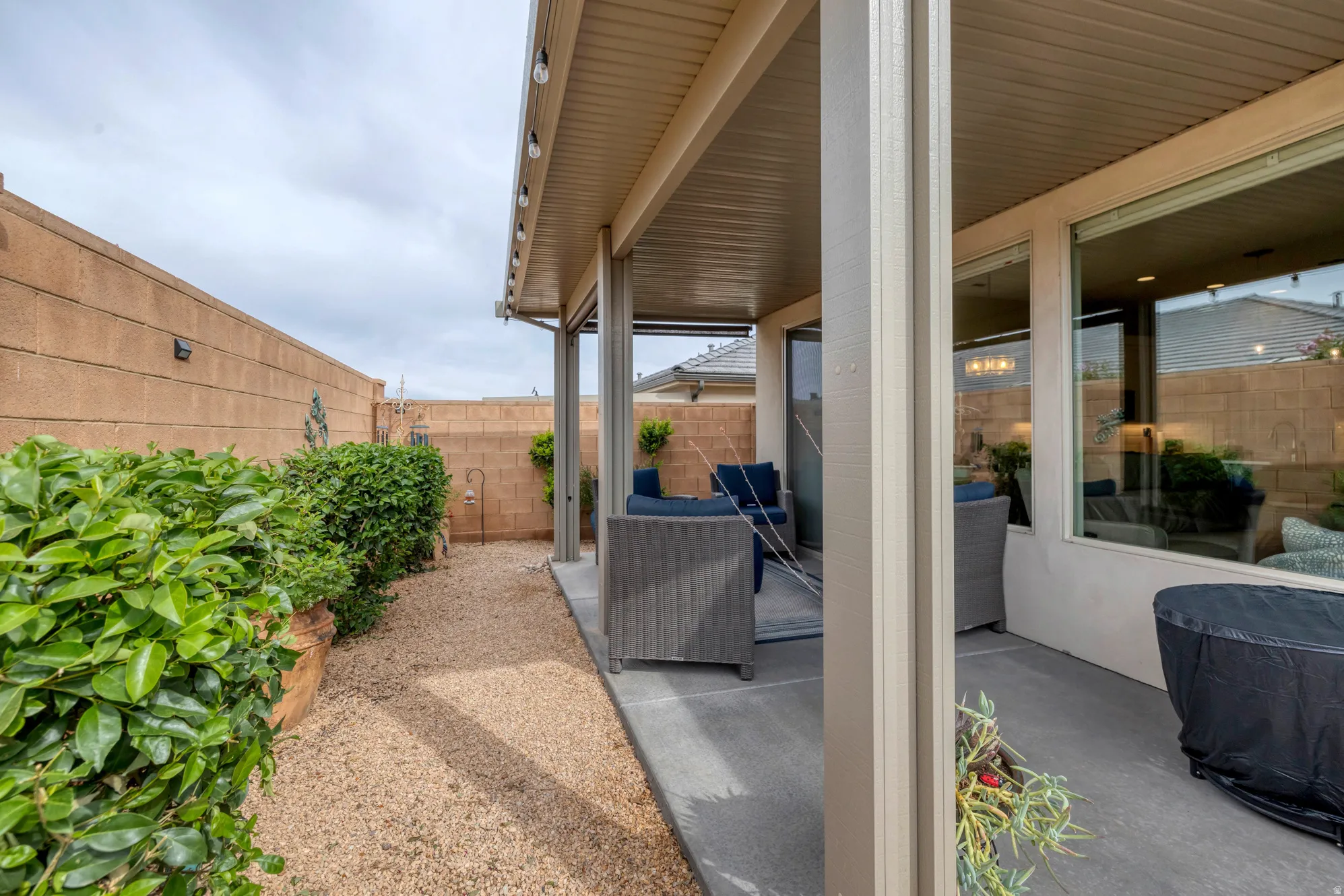 Covered patio featuring concrete flooring and integrated overhead lighting