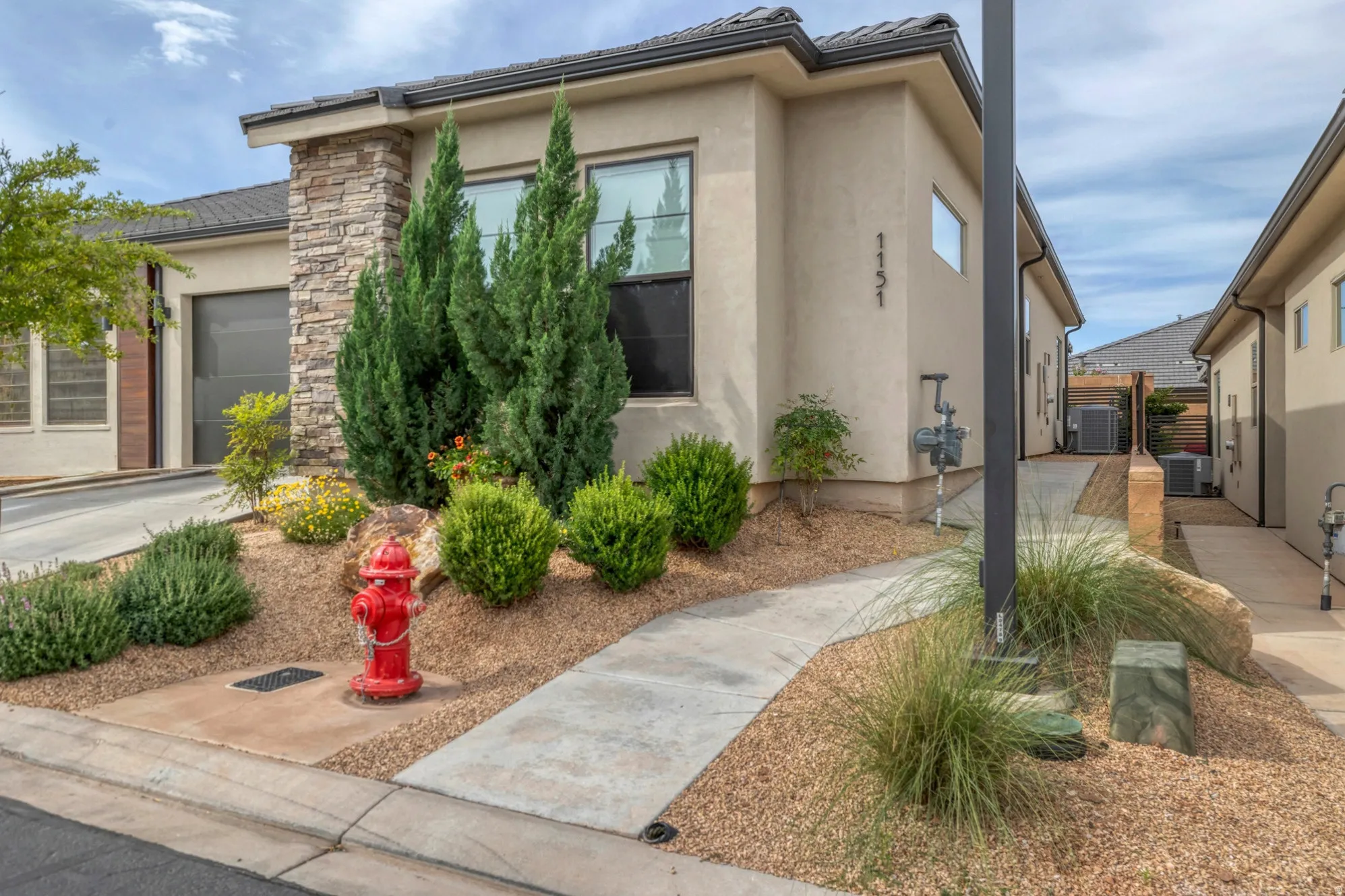 Contemporary exterior with stucco finish and stone accenting