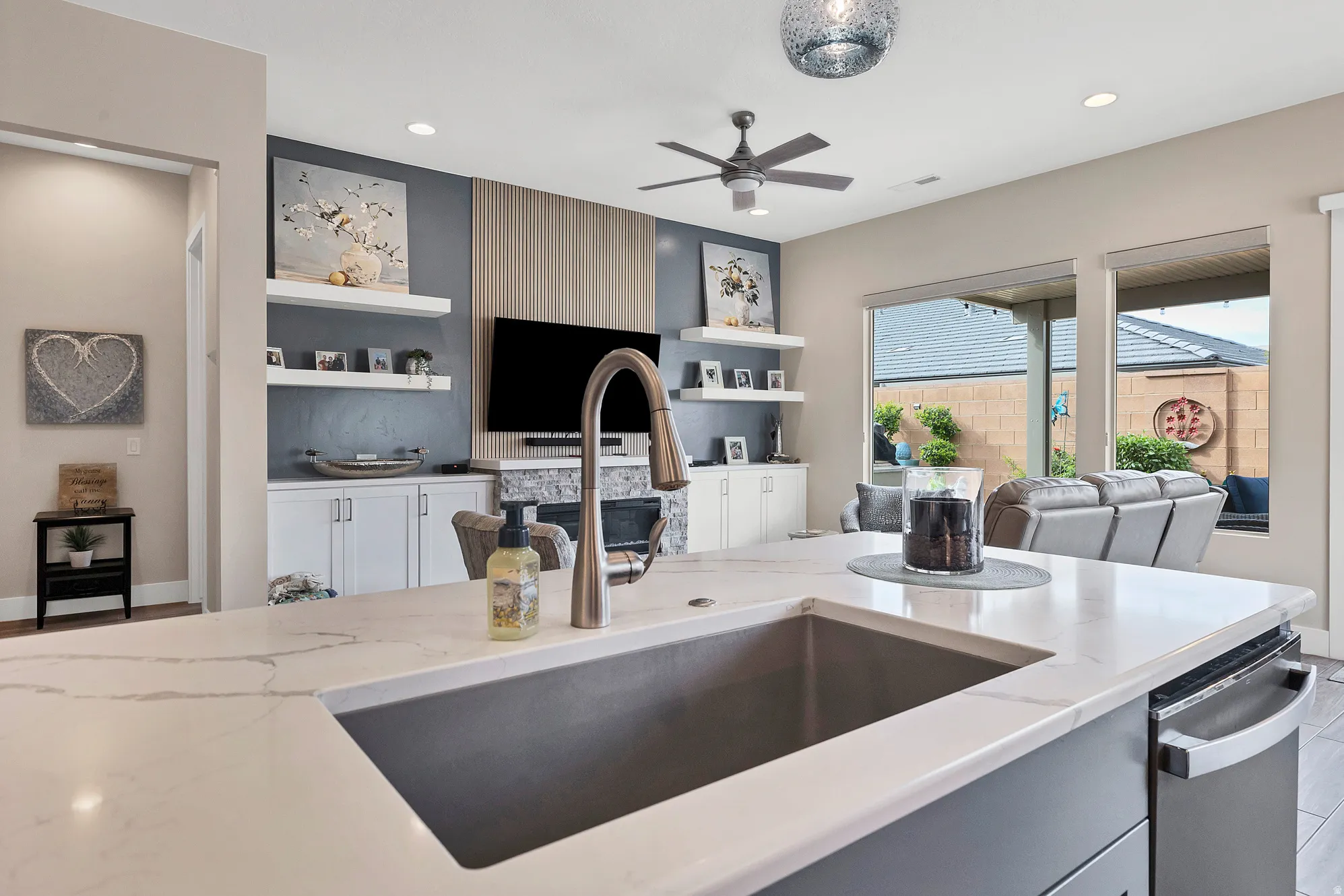 Kitchen island featuring a substantial undermount sink and a gooseneck faucet