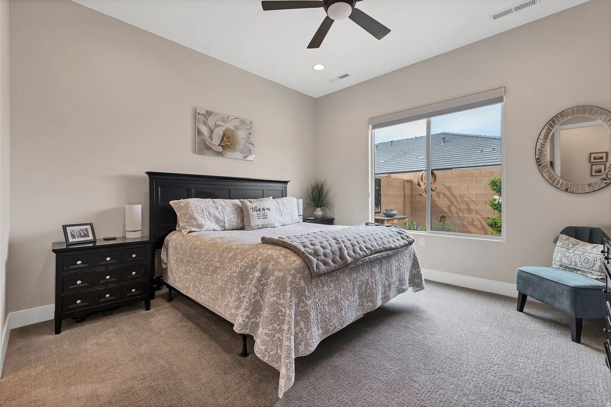 Carpeted room featuring a large window, recessed lighting, and a ceiling fan