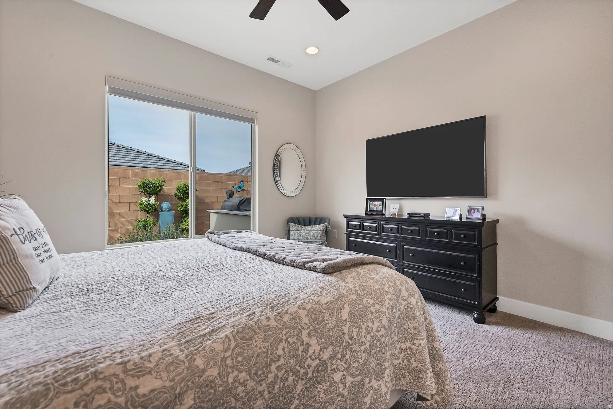 Bedroom featuring a large sliding glass door with backyard access