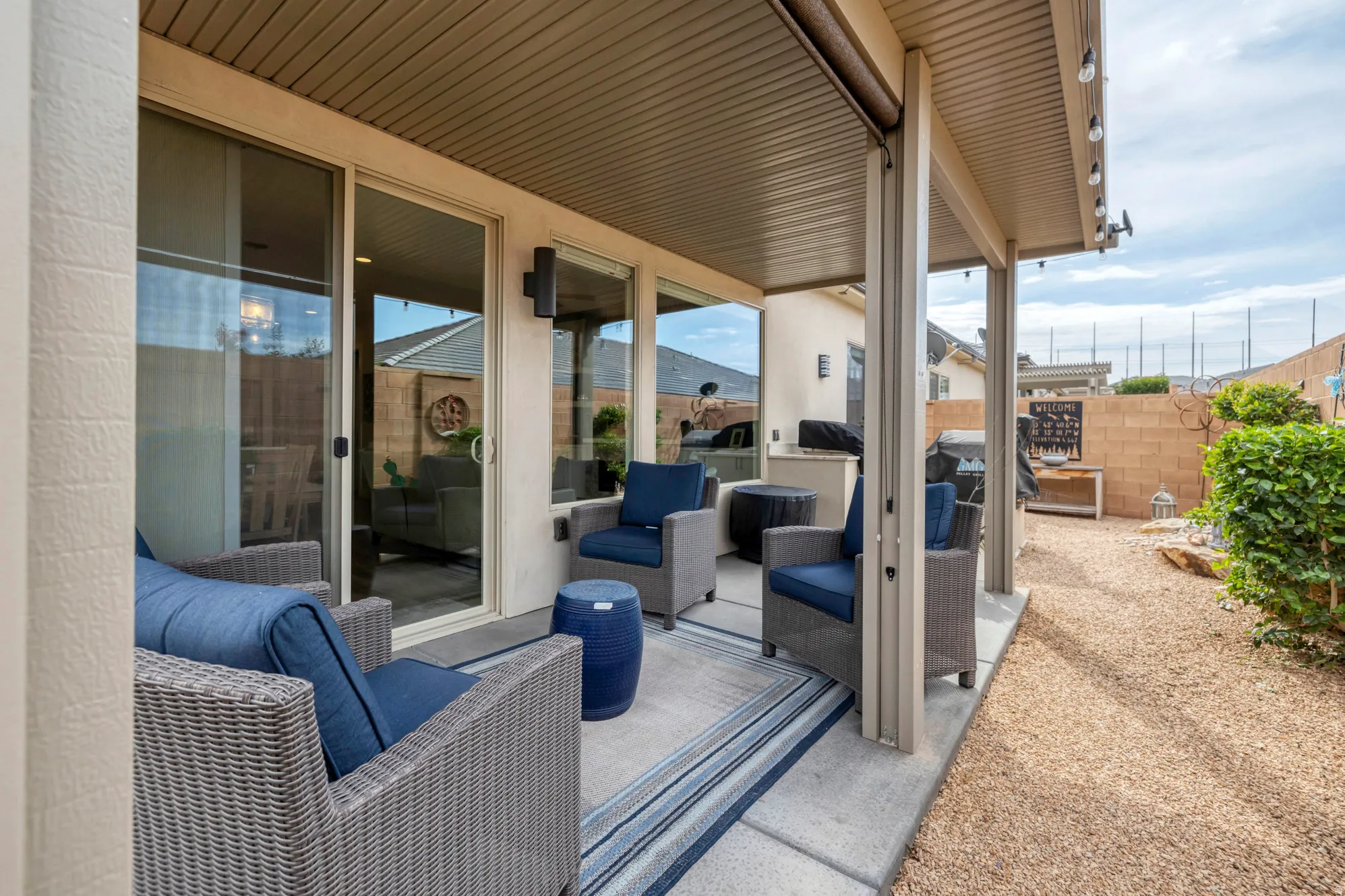Covered patio with concrete flooring and overhead string lighting