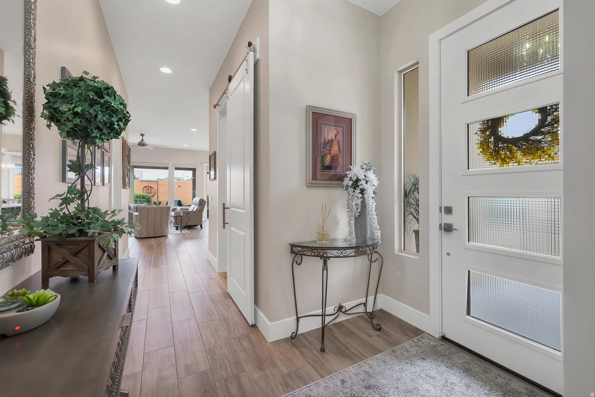Entryway featuring a contemporary front door with textured glass panels and a sidelight