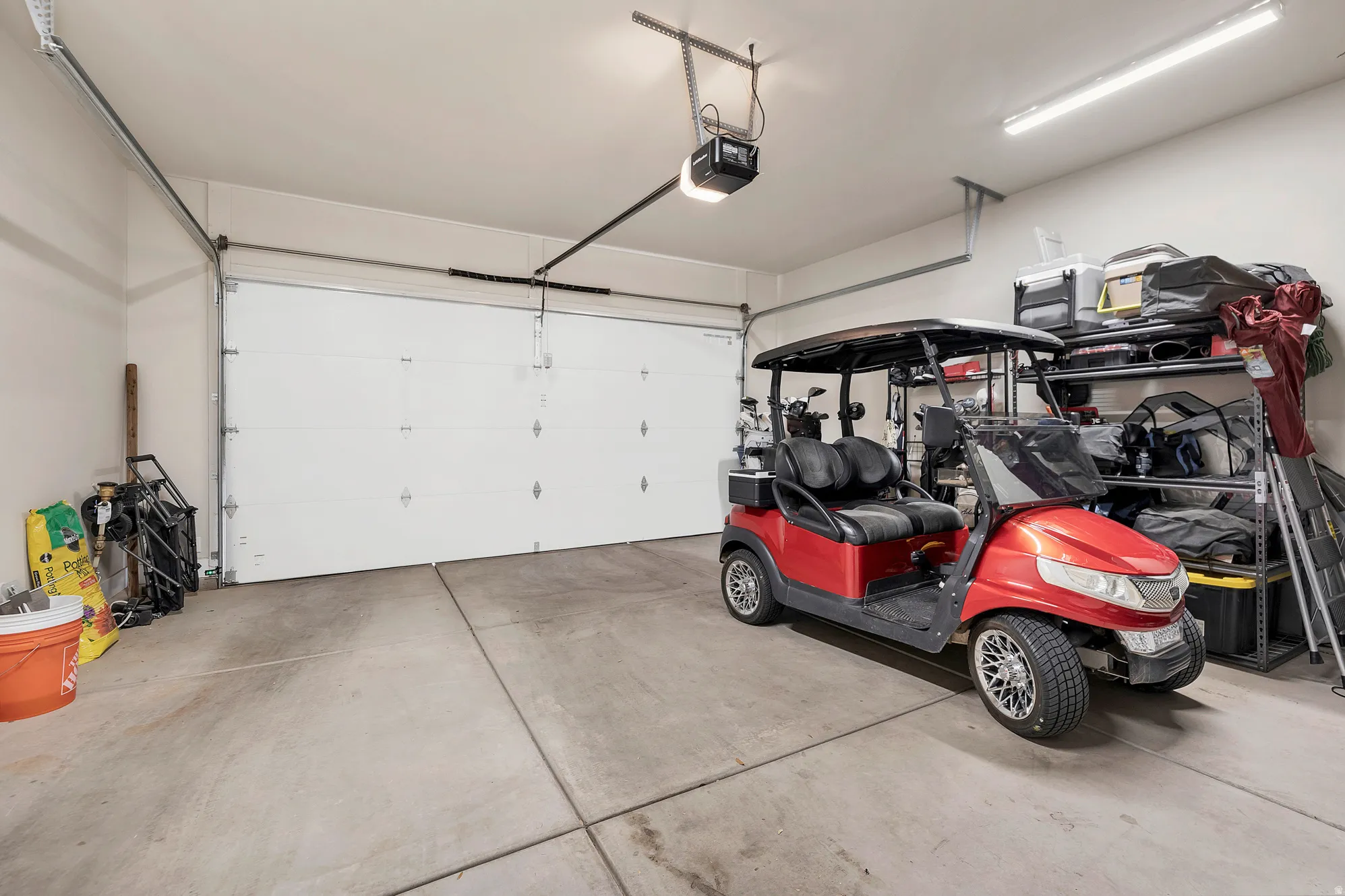 Spacious garage featuring concrete flooring and a white sectional garage door