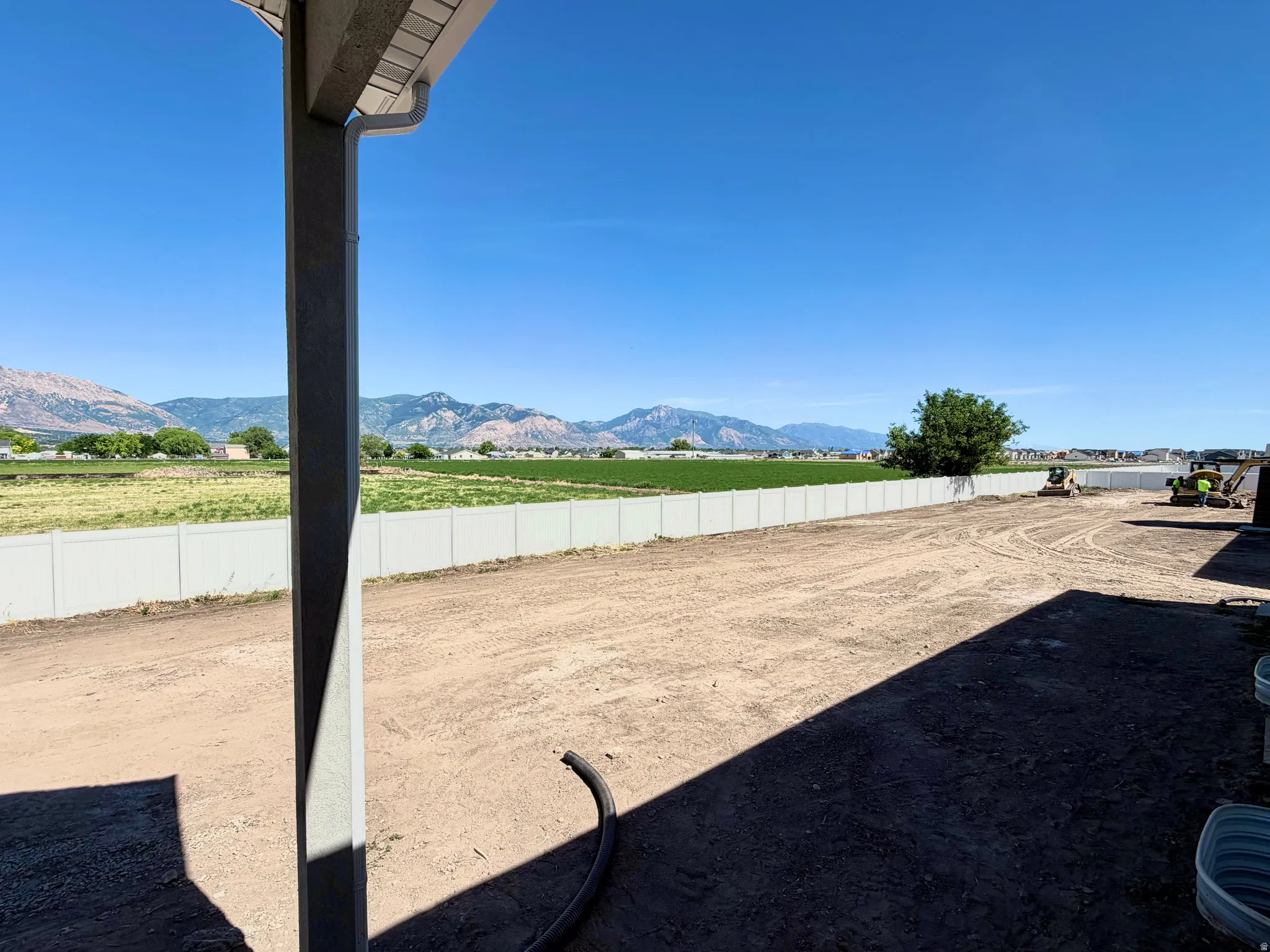 Expansive graded lot featuring a full vinyl privacy fence