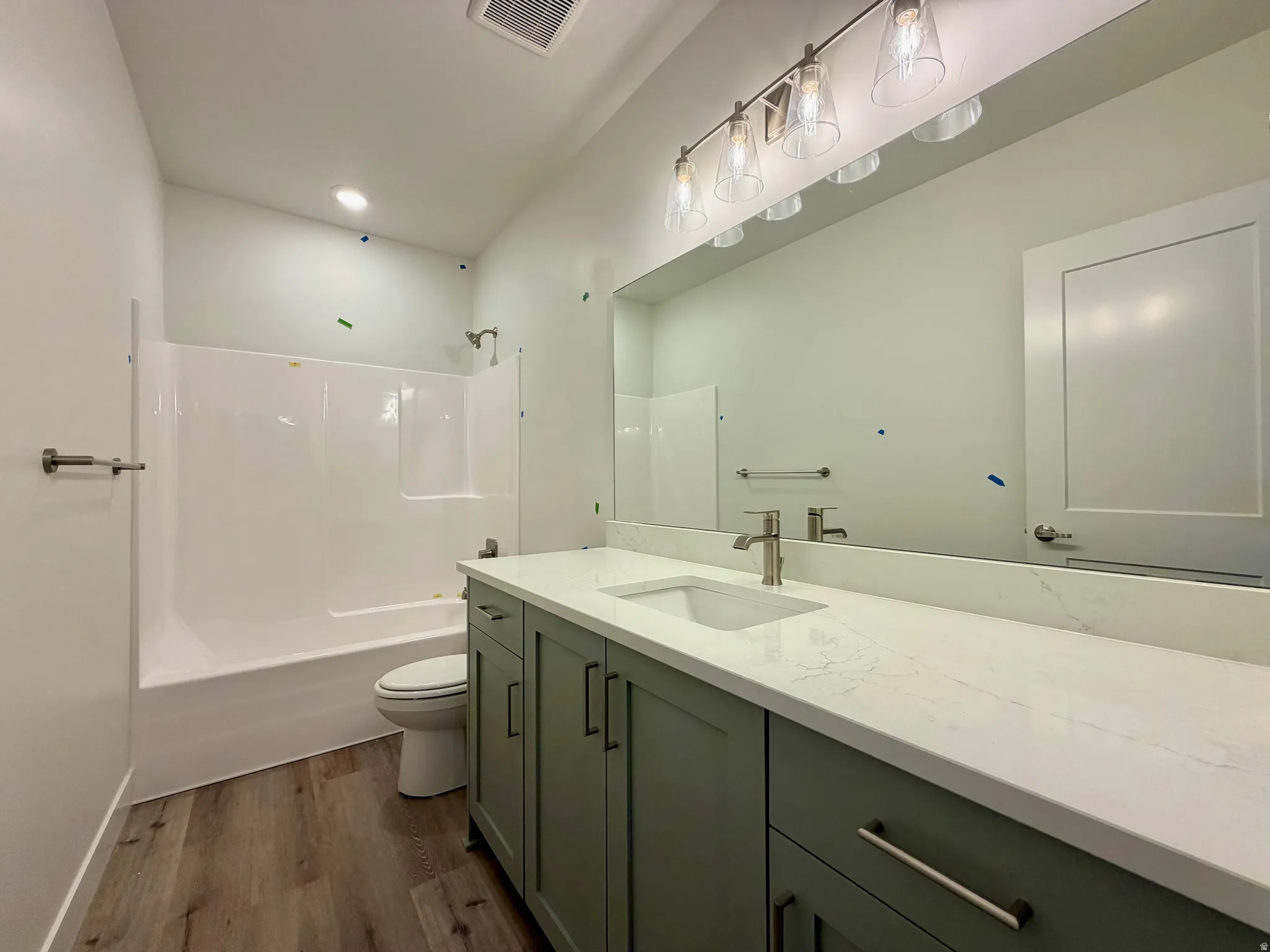 Bathroom vanity featuring a quartz countertop and a single basin sink