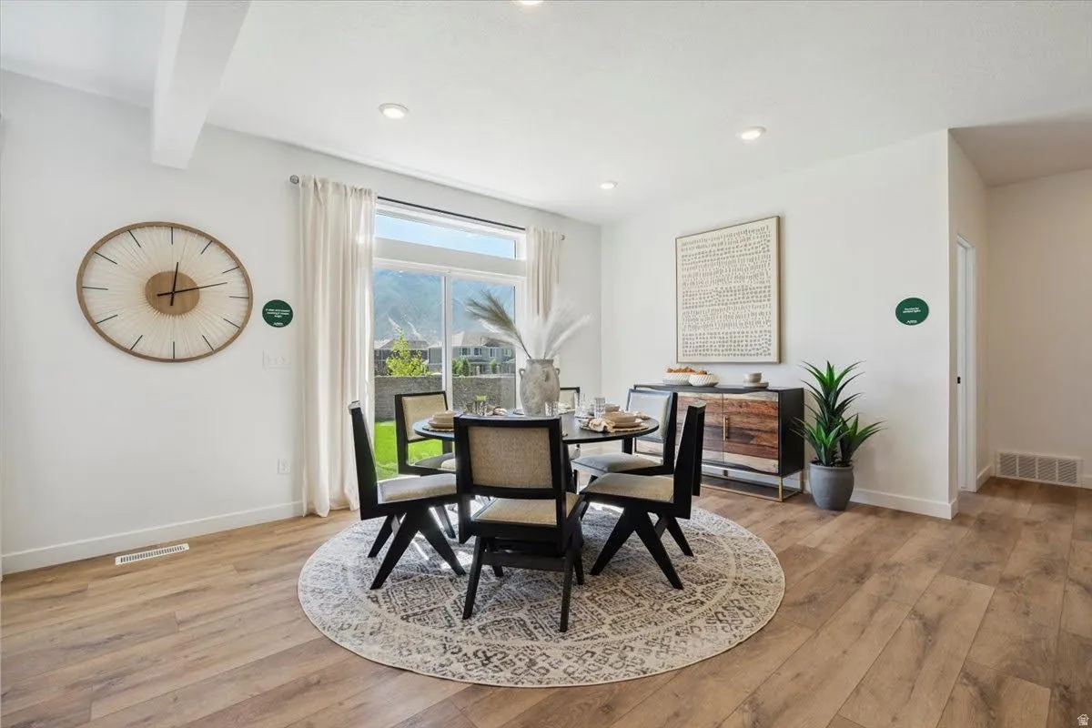 Dining area featuring wood-finish flooring and recessed lighting