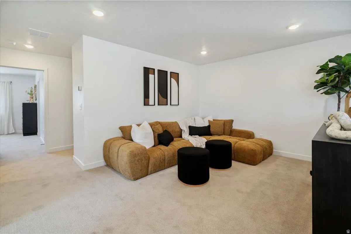 Carpeted interior space with recessed lighting and a neutral color palette