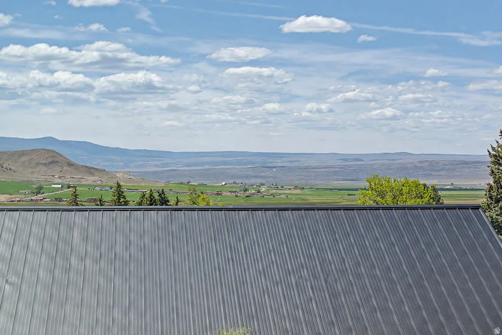 Corrugated metal roofing with distant mountain and agricultural landscapes