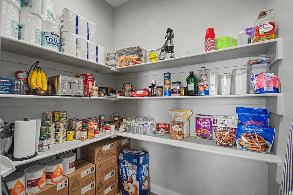 Walk-in pantry featuring extensive built-in shelving, providing abundant storage