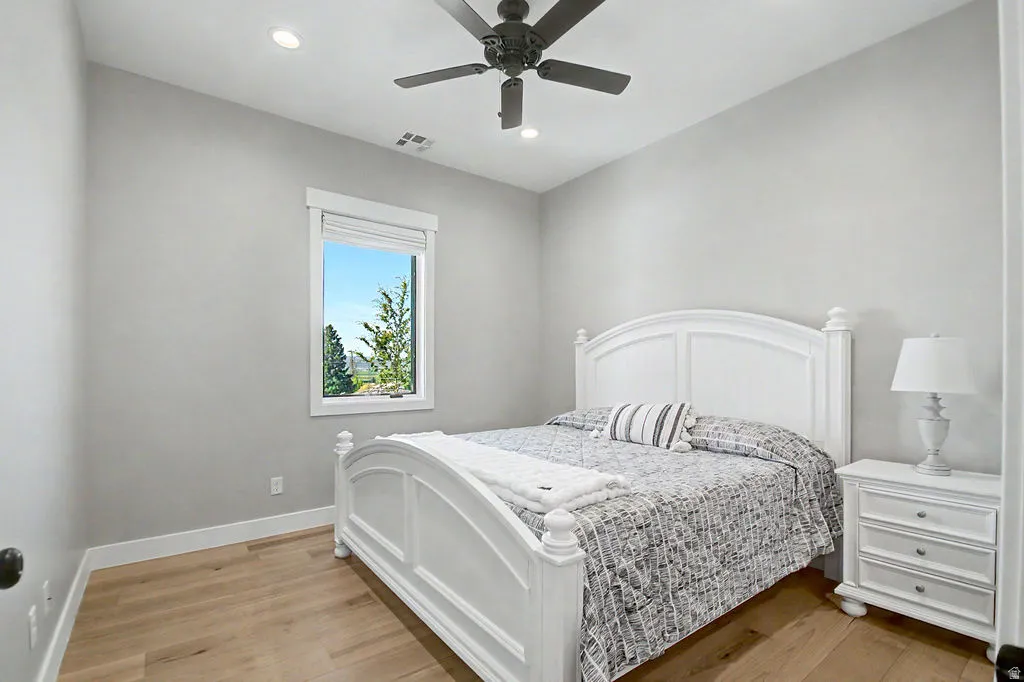 Interior room with wood-finish flooring, recessed lighting, and a ceiling fan
