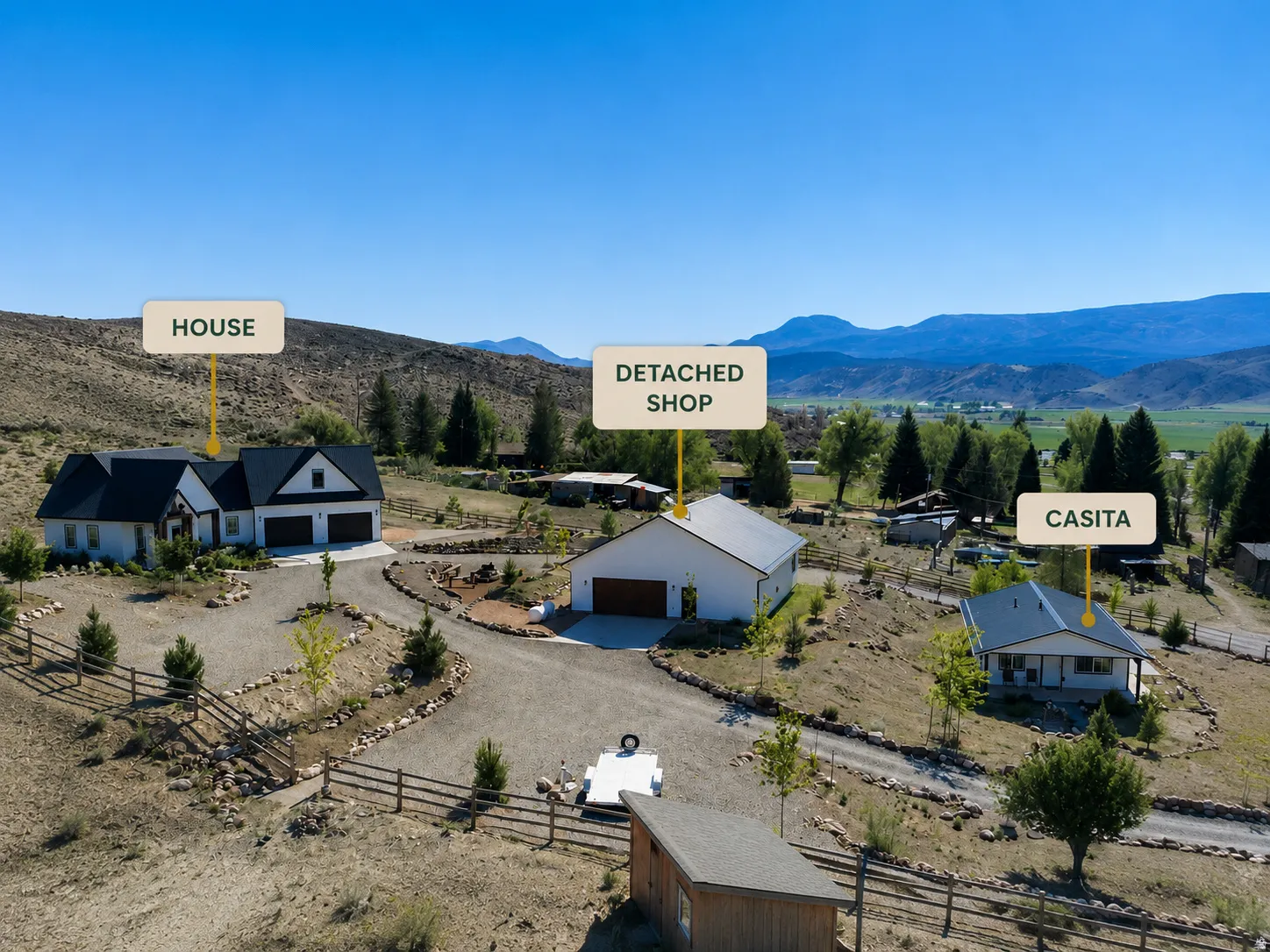 Expansive property featuring a main house with a two-car garage, a detached shop, and a separate casita