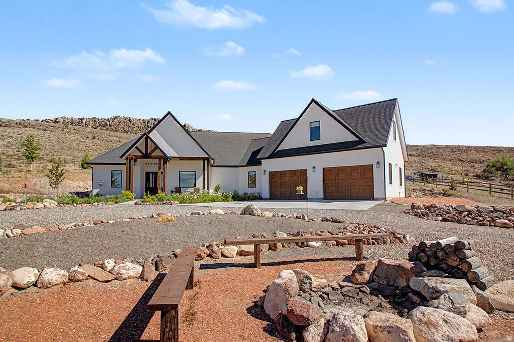 Modern farmhouse exterior with a prominent gabled roofline and white siding