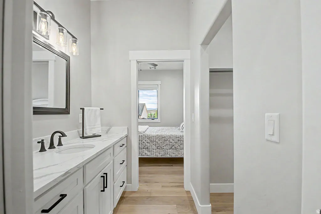 Double vanity with dual undermount sinks, stone-finish countertop, and matte black fixtures