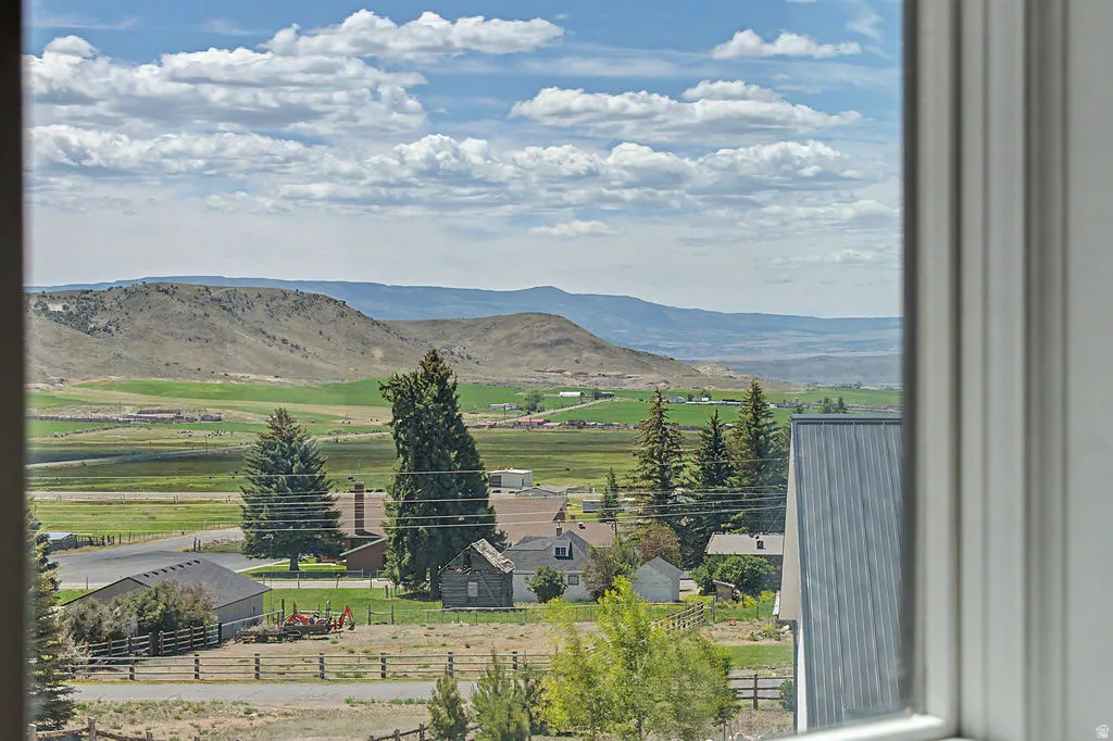 Expansive rural landscape featuring rolling hills and green fields