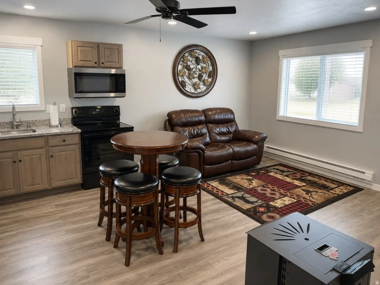 Open-concept living area featuring wood-finish flooring, recessed lighting, and a ceiling fan