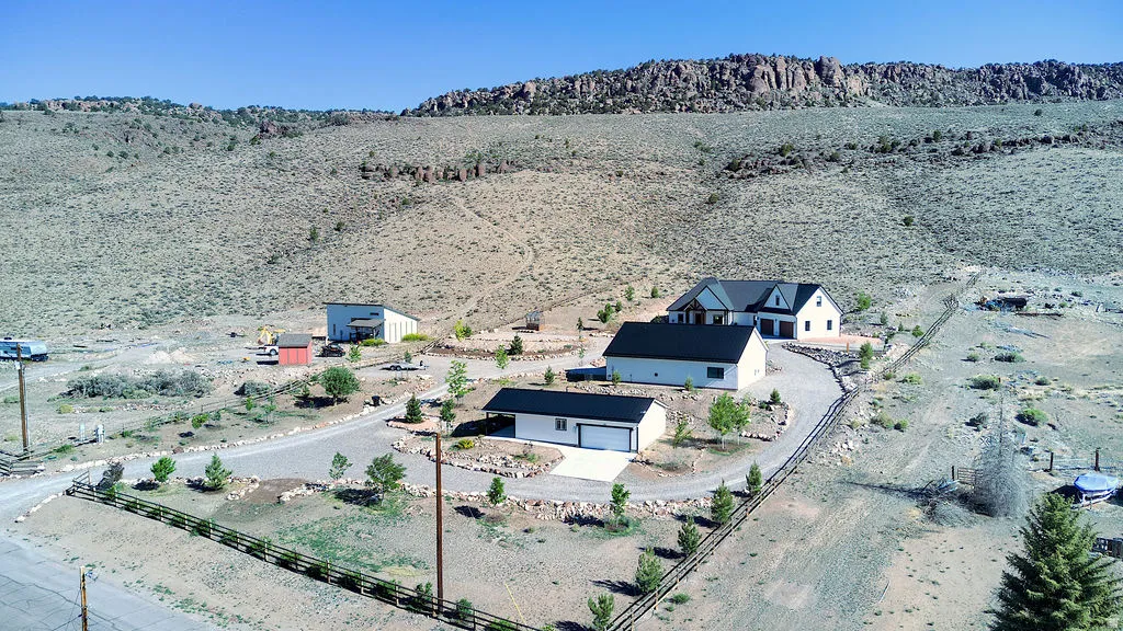 Expansive property featuring a modern residence, a detached garage, and an additional outbuilding