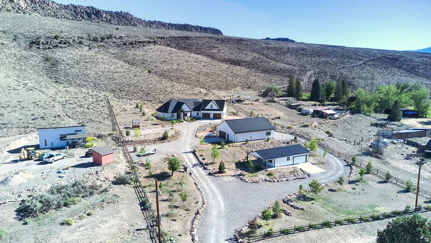 Sprawling property featuring main house, shop, and casita, and circular gravel driveway