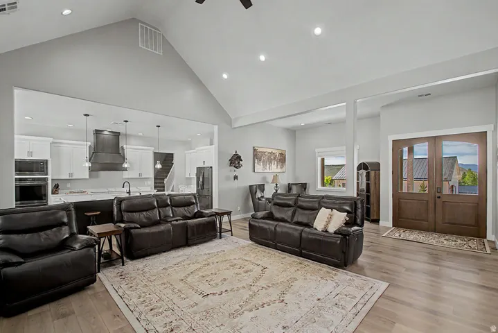 Vaulted living area featuring Hallmark Orris Maple  flooring, recessed lighting, and an open concept layout