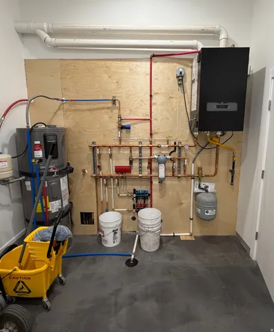 Shop mechanical room with boiler for radiant floor heating system.
