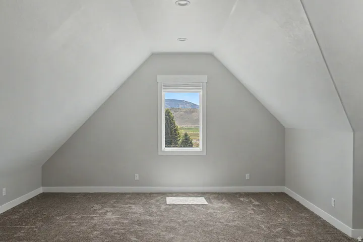 Bonus Room Carpeted room with sloped ceilings and recessed lighting