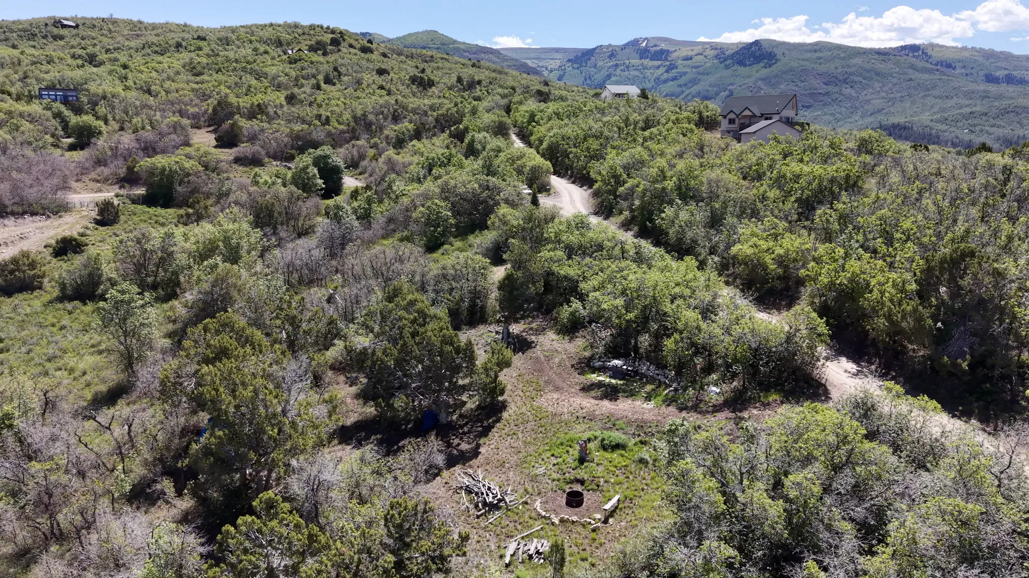 Expansive mountainous terrain featuring natural landscaping and mature trees