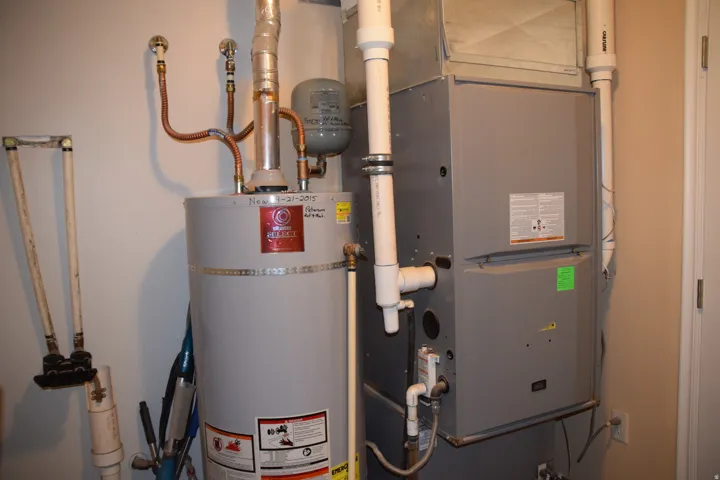 Water heater and furnace with associated plumbing and ductwork