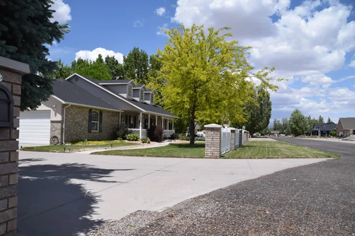 Ranch-style residence featuring a brick and siding exterior, a dark shingle roof, and a covered front porch