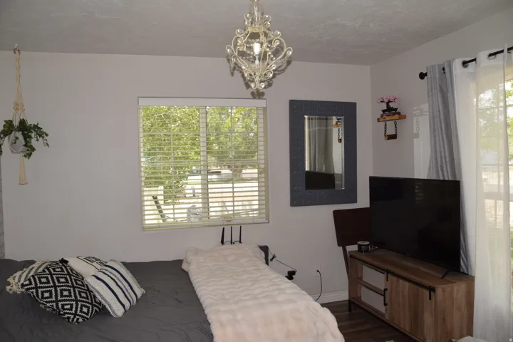 Recessed window with horizontal blinds, featuring a decorative chandelier light fixture