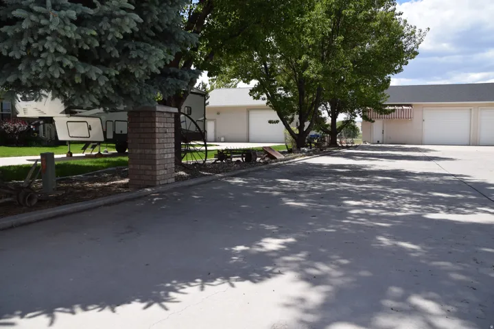 Expansive concrete driveway with multiple garage doors