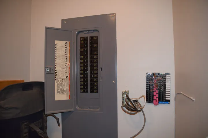 Electrical service panel with multiple breakers